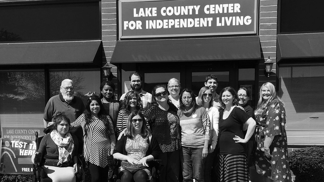 Photograph of a group of people in front of the building, below a sign that reads "Lake County Center for Independent Living"